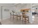 Kitchen bar seating area with wooden bar stools and views of the other living spaces at 2576 Boots Rd, Lakeland, FL 33810