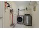 A practical laundry room features modern appliances and storage shelves for convenience at 2576 Boots Rd, Lakeland, FL 33810