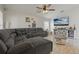 Comfortable living room with tile floors, ceiling fan, and a large sectional sofa at 2576 Boots Rd, Lakeland, FL 33810