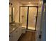 Modern bathroom featuring a granite vanity top, white cabinets, and an enclosed shower at 5635 Nw 61St Ct, Ocala, FL 34482