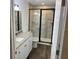 Modern bathroom featuring a granite vanity top, white cabinets, and an enclosed shower at 5635 Nw 61St Ct, Ocala, FL 34482