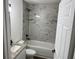Elegant bathroom features modern fixtures, granite vanity, and tiled shower-tub combination at 5635 Nw 61St Ct, Ocala, FL 34482