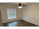 Cozy bedroom featuring modern floors and a large window providing natural light at 5635 Nw 61St Ct, Ocala, FL 34482