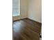 Bright bedroom featuring modern floors and a large window providing natural light at 5635 Nw 61St Ct, Ocala, FL 34482