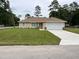Charming single-story home boasts a well-manicured lawn and attached two-car garage at 5635 Nw 61St Ct, Ocala, FL 34482