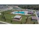 Aerial view of community pool, playground, and surrounding neighborhood showcasing amenities and Gathering-friendly environment at 3628 Diving Dove Ln, Bartow, FL 33830