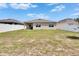 Spacious backyard featuring lush green grass, complimented by white vinyl fencing and a covered patio at 3628 Diving Dove Ln, Bartow, FL 33830