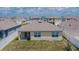 Rear view of the house showing a covered patio and well-maintained lawn at 3628 Diving Dove Ln, Bartow, FL 33830