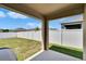 Secluded backyard featuring a covered patio and a clean white fence at 3628 Diving Dove Ln, Bartow, FL 33830