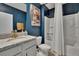 A renovated bathroom with granite counters, white vanity, and blue walls at 3628 Diving Dove Ln, Bartow, FL 33830