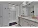 Bright bathroom featuring dual sinks with granite countertops, a walk-in shower, and modern fixtures at 3628 Diving Dove Ln, Bartow, FL 33830
