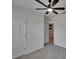 Bedroom with light grey carpet, a ceiling fan, and a white door at 3628 Diving Dove Ln, Bartow, FL 33830