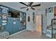 A bedroom with light gray carpet and a sports-themed wall with framed jerseys at 3628 Diving Dove Ln, Bartow, FL 33830