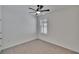 An empty bedroom features a ceiling fan, light grey carpet, and a window with white blinds at 3628 Diving Dove Ln, Bartow, FL 33830
