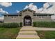 Community building featuring a secure gated entry, well-maintained greenery, and a neutral exterior at 3628 Diving Dove Ln, Bartow, FL 33830