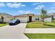 Well-kept single-story home with a lush green lawn, showcasing neat landscaping at 3628 Diving Dove Ln, Bartow, FL 33830