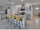 Modern kitchen with an island and granite countertops, offering ample space for cooking and entertaining at 3628 Diving Dove Ln, Bartow, FL 33830