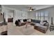 Living room with tile flooring, a large sectional sofa, and views to other rooms in the house at 3628 Diving Dove Ln, Bartow, FL 33830