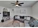 Cozy living room with a sectional sofa, neutral accents, a ceiling fan, and modern decor at 3628 Diving Dove Ln, Bartow, FL 33830