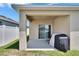 Covered patio area featuring a sliding glass door and space for outdoor grilling at 3628 Diving Dove Ln, Bartow, FL 33830