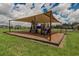 Community playground area featuring shade, mulch, and green space, perfect for outdoor fun at 3628 Diving Dove Ln, Bartow, FL 33830