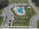 Aerial view of community pool with ample parking, picnic area, and playground for residents at 3628 Diving Dove Ln, Bartow, FL 33830