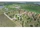Beautiful aerial shot showing the property's long driveway, mature trees, and surrounding rural landscape near a lake at 9419 Alturas Babson Park Cutoff Rd, Bartow, FL 33830
