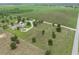Expansive property featuring a modern single-story home with a circular driveway and lush green landscaping at 9419 Alturas Babson Park Cutoff Rd, Bartow, FL 33830
