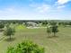 Expansive aerial view of a stately home on a large lot with mature trees and circular driveway at 9419 Alturas Babson Park Cutoff Rd, Bartow, FL 33830