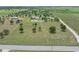 An aerial view shows the home, detached garage, and very large lot at 9419 Alturas Babson Park Cutoff Rd, Bartow, FL 33830