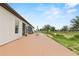 A beautiful back deck with a view of a wide green field is furnished with outdoor seating at 9419 Alturas Babson Park Cutoff Rd, Bartow, FL 33830