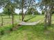 A hammock strung between trees provides relaxation in the large grassy backyard at 9419 Alturas Babson Park Cutoff Rd, Bartow, FL 33830