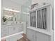 Lavish bathroom with glass shower, chandelier, and white cabinets at 9419 Alturas Babson Park Cutoff Rd, Bartow, FL 33830
