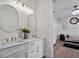 Bright bathroom features dual sinks, wood floors, and elegant lighting at 9419 Alturas Babson Park Cutoff Rd, Bartow, FL 33830