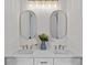 Bright bathroom features dual sinks, neutral colors, and elegant mirrors at 9419 Alturas Babson Park Cutoff Rd, Bartow, FL 33830