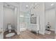 Elegant bathroom features a chandelier, double vanity, and glass-enclosed shower at 9419 Alturas Babson Park Cutoff Rd, Bartow, FL 33830