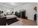 Spacious bedroom featuring hardwood floors, large windows, drum set and modern black storage units at 9419 Alturas Babson Park Cutoff Rd, Bartow, FL 33830