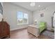 Bright bedroom features stylish decor, wood floors, and large window at 9419 Alturas Babson Park Cutoff Rd, Bartow, FL 33830