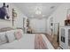 Bedroom with rustic decor, including bed with decorative pillows, hardwood floors and a full-length mirror at 9419 Alturas Babson Park Cutoff Rd, Bartow, FL 33830
