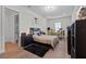 Large bedroom featuring hardwood floors, large windows, a bed and modern black storage units at 9419 Alturas Babson Park Cutoff Rd, Bartow, FL 33830