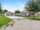 Spacious home with a detached two-car garage and expansive driveway at 9419 Alturas Babson Park Cutoff Rd, Bartow, FL 33830