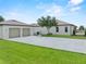 Rear view of home shows garage, large driveway, and back deck at 9419 Alturas Babson Park Cutoff Rd, Bartow, FL 33830