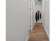 Hallway features wood floors, neutral colors, and access to other rooms at 9419 Alturas Babson Park Cutoff Rd, Bartow, FL 33830