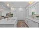Spacious kitchen with an island, double sinks, white cabinetry, and modern appliances at 9419 Alturas Babson Park Cutoff Rd, Bartow, FL 33830