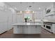 Bright kitchen featuring an island, white cabinetry, modern appliances, and pendant lighting at 9419 Alturas Babson Park Cutoff Rd, Bartow, FL 33830