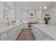 Elegant kitchen featuring quartz countertops, double sinks, and gold hardware at 9419 Alturas Babson Park Cutoff Rd, Bartow, FL 33830
