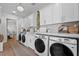 Spacious laundry room featuring modern washer and dryer units, complemented by ample storage and stylish finishes at 9419 Alturas Babson Park Cutoff Rd, Bartow, FL 33830