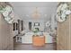 Elegant living room featuring a grand chandelier, fireplace, and comfortable seating at 9419 Alturas Babson Park Cutoff Rd, Bartow, FL 33830
