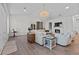 Bright living room with hardwood floors, a stunning chandelier, and cozy seating area at 9419 Alturas Babson Park Cutoff Rd, Bartow, FL 33830