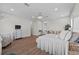 Bright main bedroom features hardwood floors, sitting area, and elegant chandelier lighting at 9419 Alturas Babson Park Cutoff Rd, Bartow, FL 33830